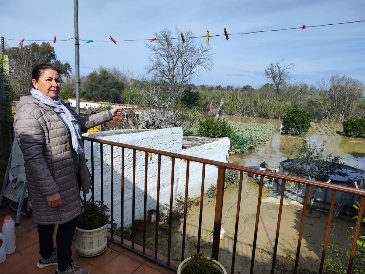 Ana martínez, vecina de El Mohíno, muestra la trasera de su vivienda, completamente anegada.
