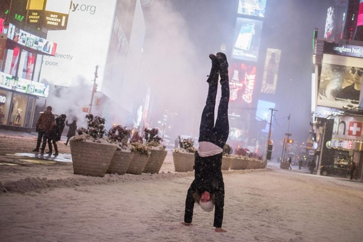 Jamina Goop, de Liechtenstein, hace la vertical en una Times Square nevada.
