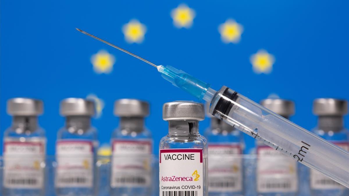 Vials labelled  Astra Zeneca COVID-19 Coronavirus Vaccine  and a syringe are seen in front of a displayed EU flag in this illustration taken March 10  2021  REUTERS Dado Ruvic Illustration