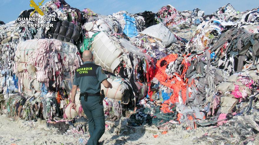 Un agente de la Guardia Civil junto a parte del material intervenido