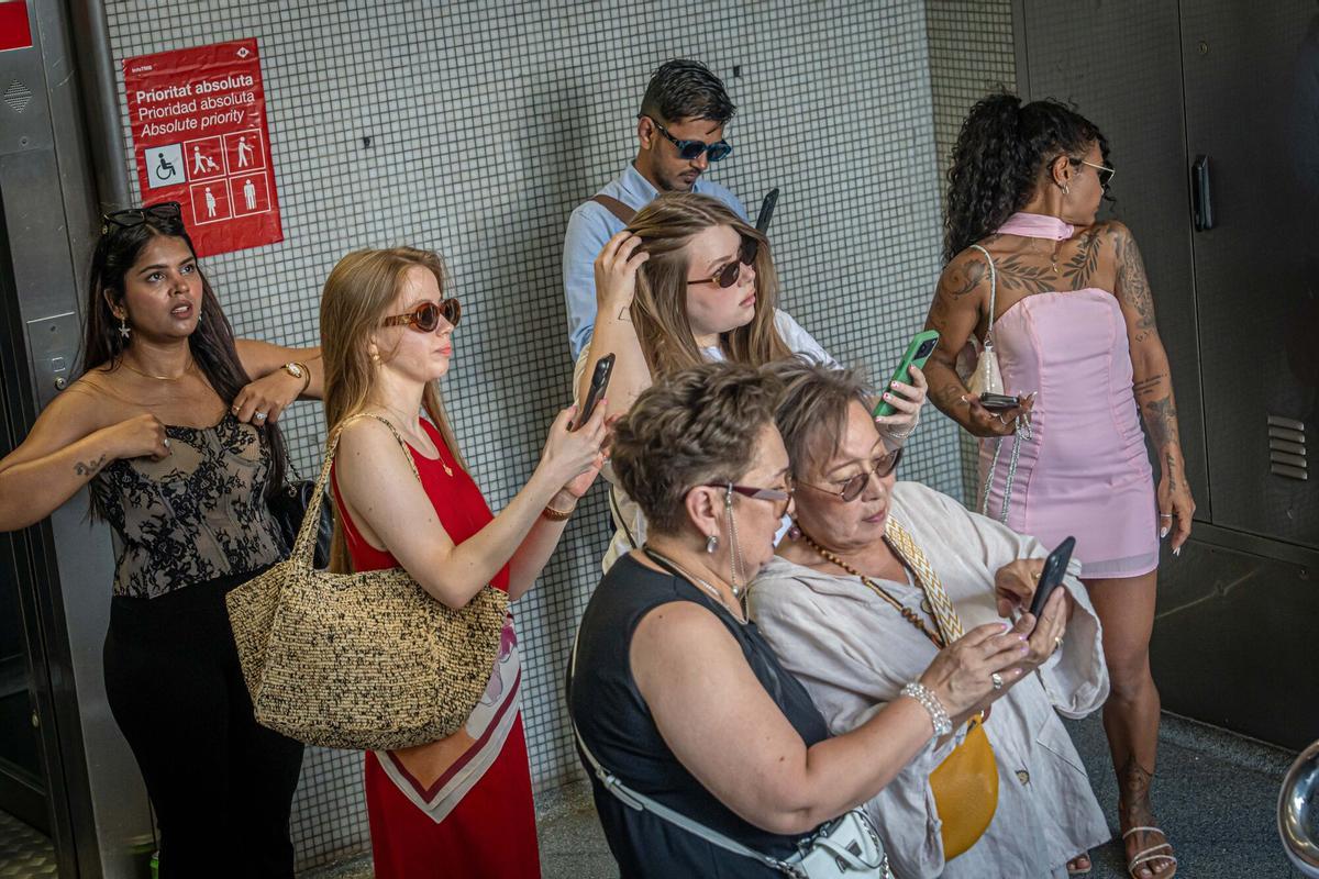Un grupo de turistas se acicala y espera su turno para el ritual de la escalera.