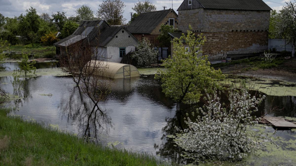 FILE PHOTO: A house is seen flooded at an area after Ukrainian military forces opened a dam to flood an residencial area in order to stop advance of Russian forces to arrive to the capital city of Kyiv, in Demydiv, Ukraine