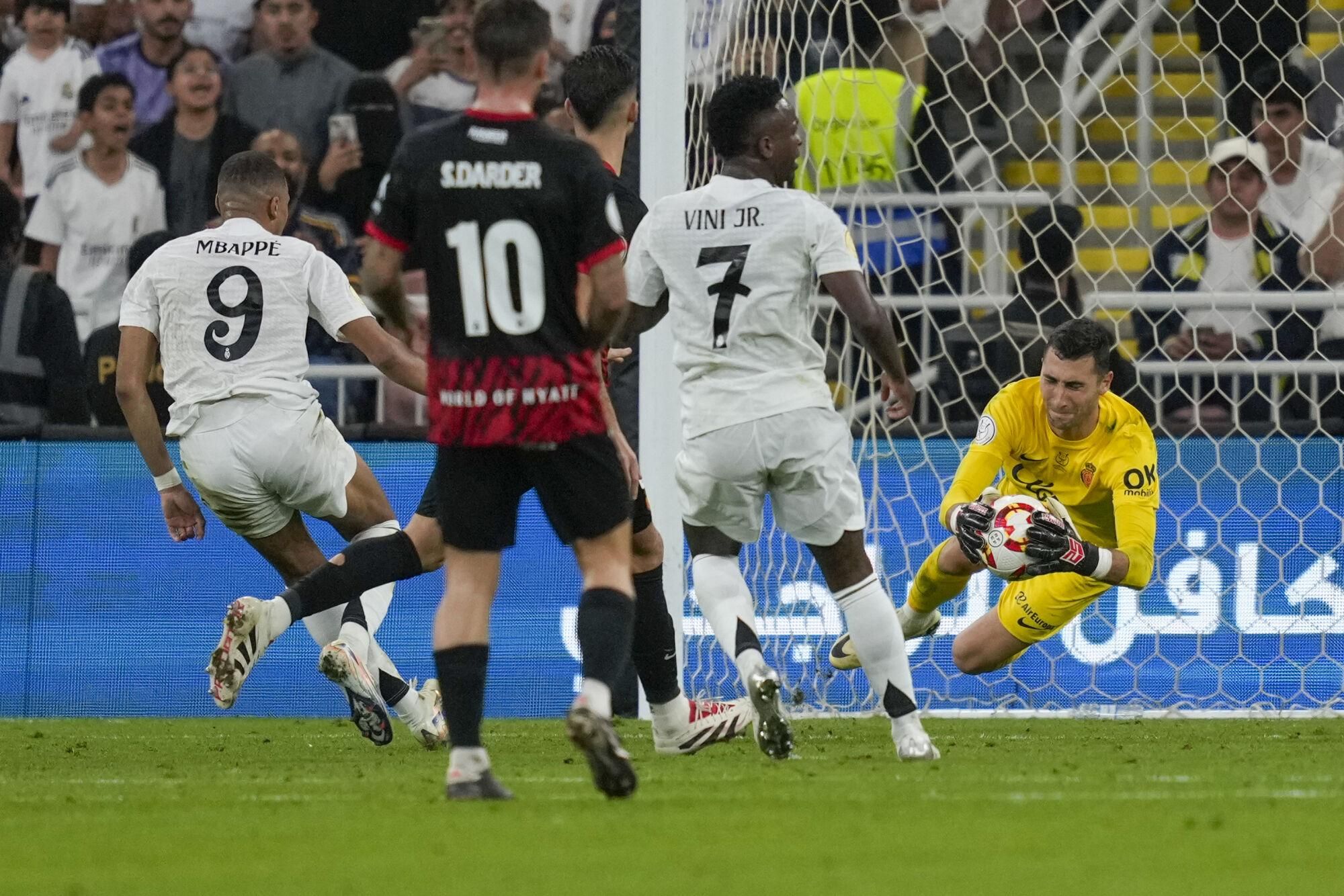 Mallorca's goalkeeper Dominik Greif saves Real Madrid's Kylian Mbappe's shot during the Spanish Super Cup semifinal soccer match between Real Madrid and Mallorca at the King Abdullah Stadium in Jeddah, Saudi Arabia, Thursday, Jan. 9, 2025. (AP Photo/Altaf Qadri)