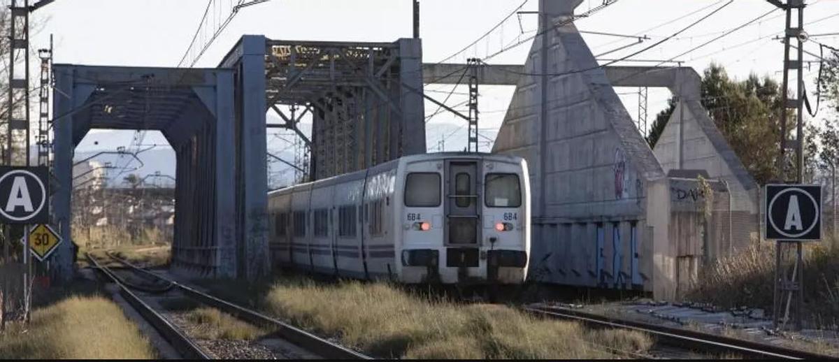 Puente metálico entre Alzira y Carcaixent y, al lado, la vía de alta velocidad sin uso.