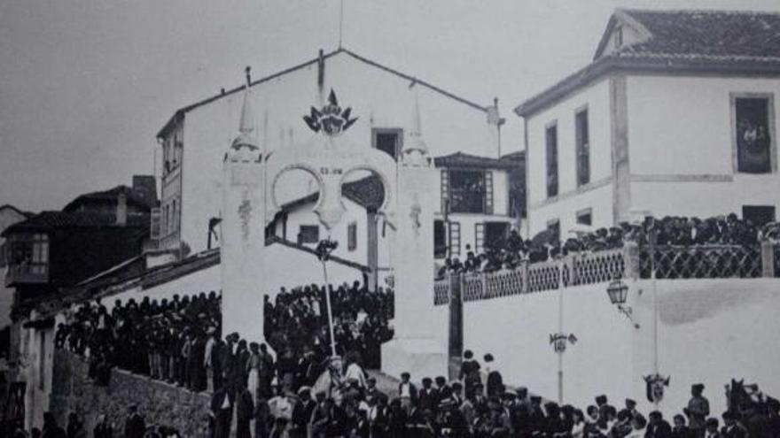 Los luanquinos esperan la llegada de los Reyes Alfonso XIII y Victoria Eugenia en el muelle de Luanco, con uno de los arcos diseñados para la ocasión, en el centro.