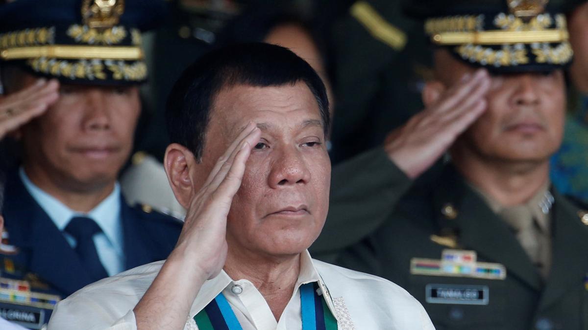 Philippine President Rodrigo Duterte salutes with other military officers during a anniversary celebration of the Armed Forces at a military camp in Quezon city