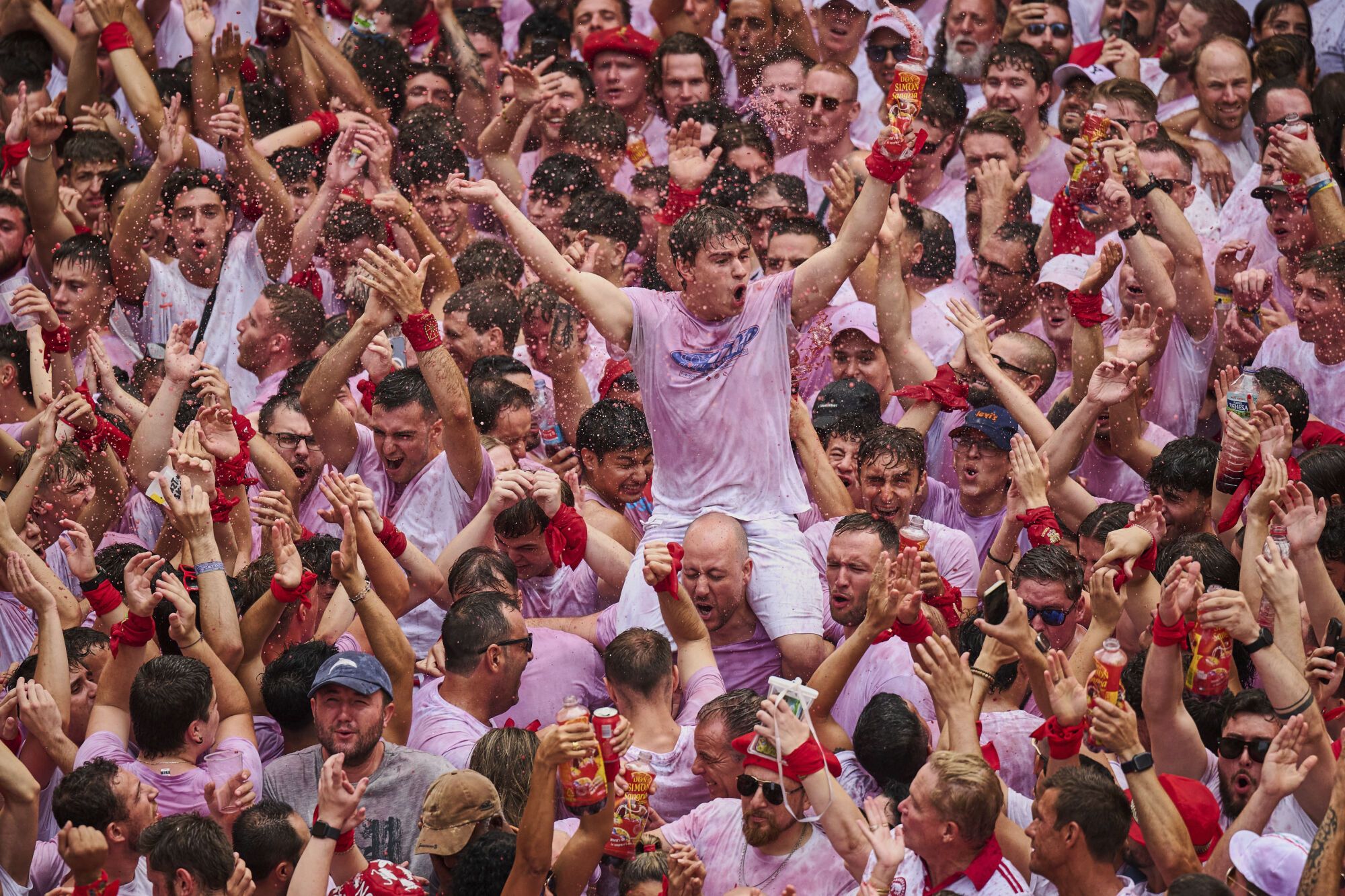 Revelers pack the main square during the start of nine days of uninterrupted partying in Pamplona's famed running-of-the-bulls festival in Pamplona, Spain, Sunday, July 6, 2025. (AP Photo/Miguel Oses). EDITORIAL USE ONLY/ONLY ITALY AND SPAIN