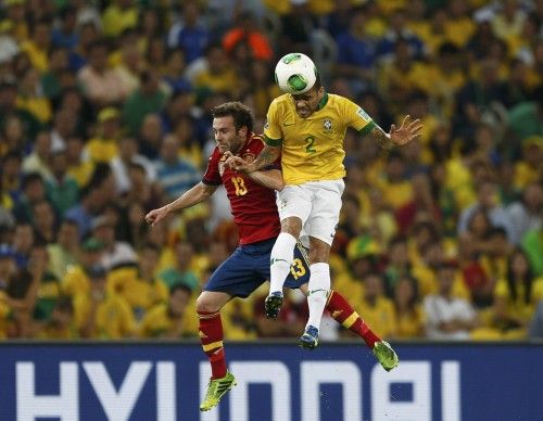 Spain's Mata and Brazil's Alves fight for the ball during their Confederations Cup final soccer match at the Estadio Maracana in Rio de Janeiro