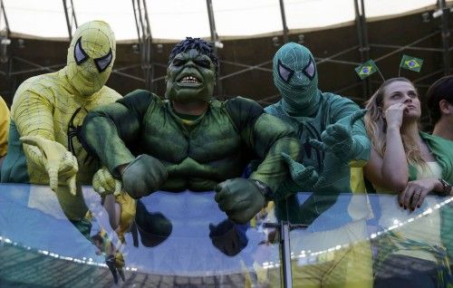 Fans dressed in superhero costumes wait for the start of the 2014 World Cup round of 16 game between Brazil and Chile at the Mineirao stadium in Belo Horizonte