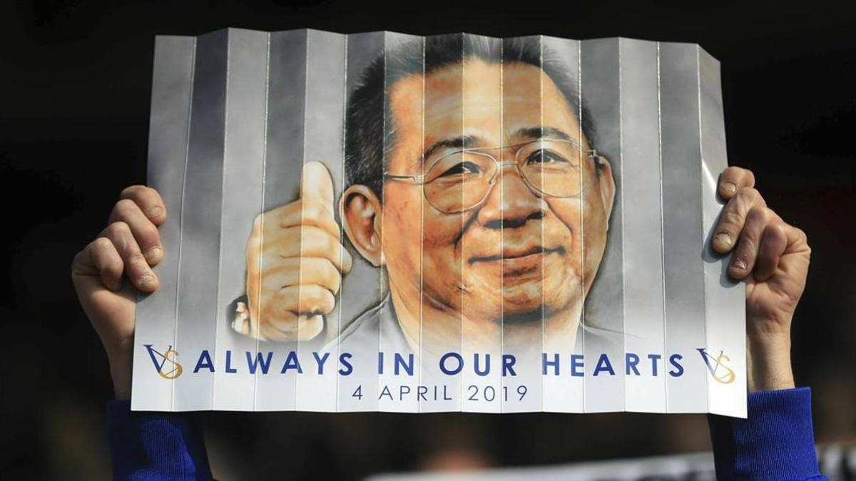 A Leicester City fan holds up a banner in honour of the birthday of late chairman Vichai Srivaddhanaprabha  during the English Premier League soccer match between Leicester City and Bournemouth at the King Power