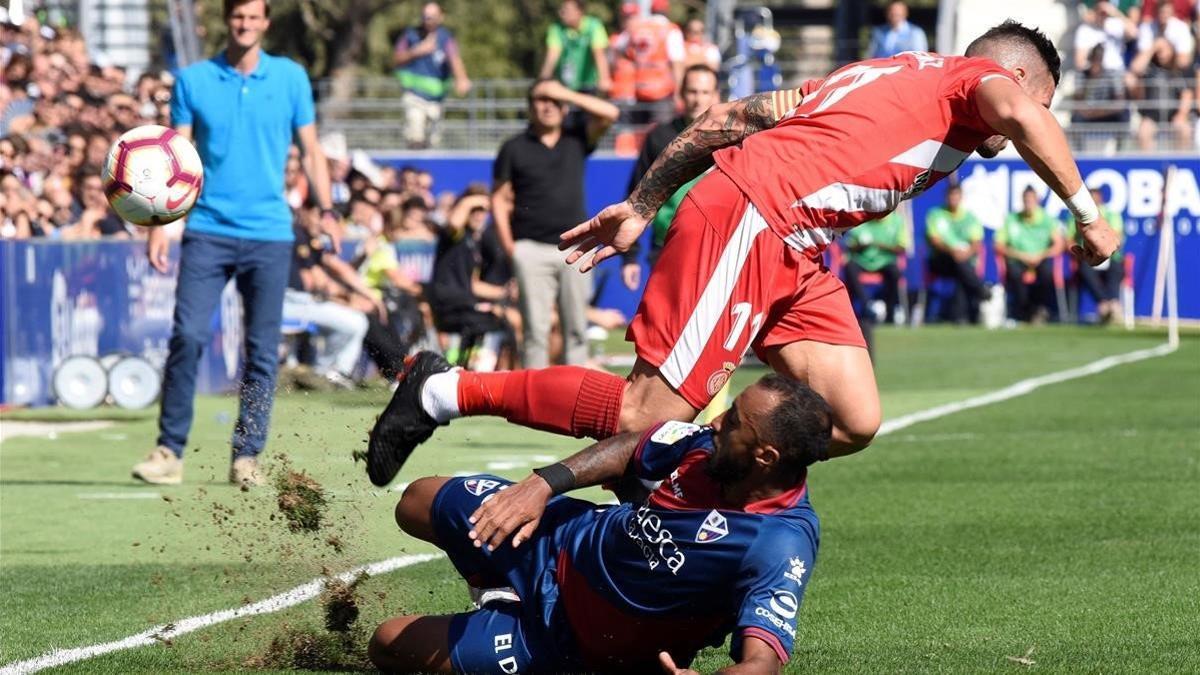 Akapo, del Huesca, disputa un balón a Aday Benítez, del Girona.