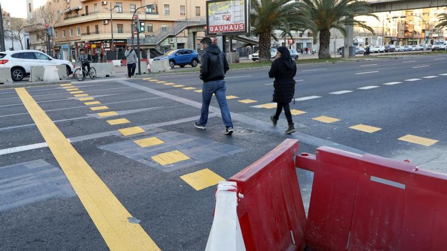 Peatones y ciclistas cruzan la avenida del Cid a pie de calle a la altura de la calle Burgos.