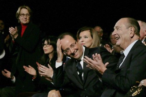 French President Francois Hollande and French President Jacques Chirac react at the end of the award ceremony for  the "Prix de la Fondation Chirac" at the Musee du Quai Branly in Paris