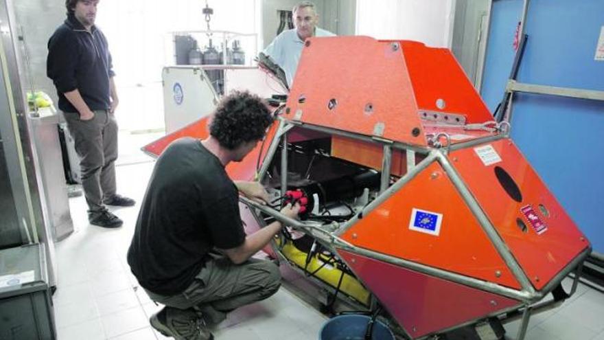 Integrantes de la expedición al Cañón de Avilés, ayer, preparando el trineo fotogramétrico que lleva cámaras para recoger imágenes del fondo marino.