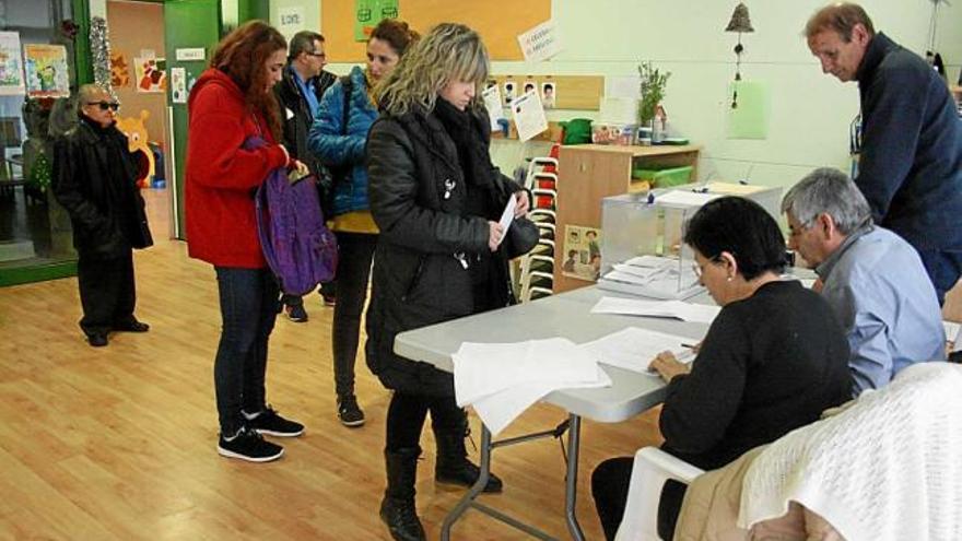 Veïns de Navàs exercint el seu vot en una de les meses diumenge