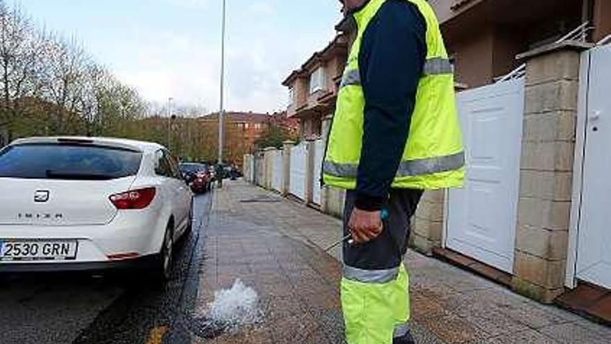 Un técnico de Aguas de Avilés, ayer, drenando la red en la calle de José Cueto.