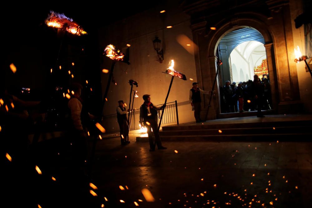 Villagers hold torches to represent light and ...