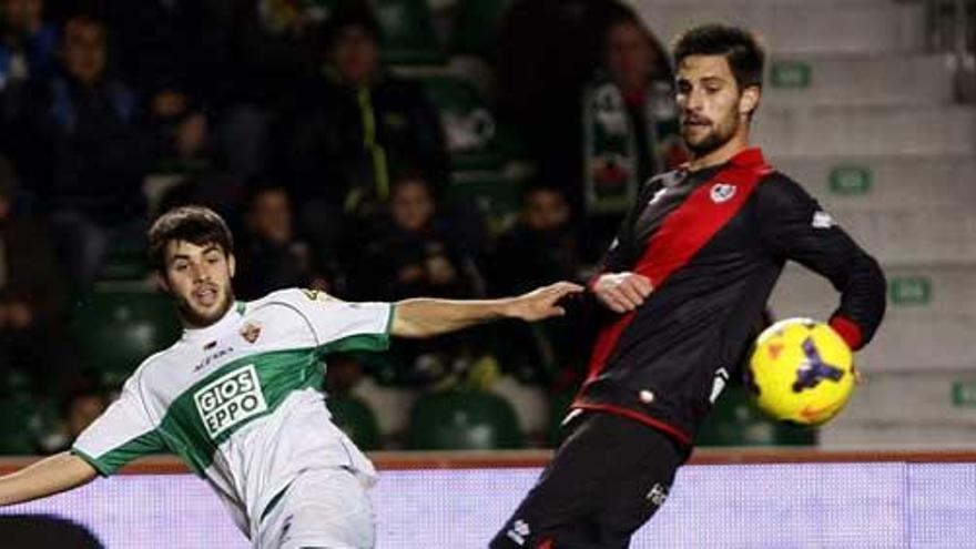 Carles Gil centra ante  Adrián González, en el partido Elche-Rayo de la pasada temporada