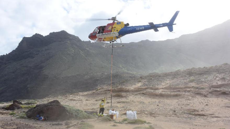 Un helicóptero del Cabildo retira la basura de la costa de Artenara.