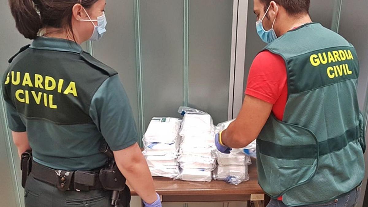 Agentes de la Guardia Civil, con la cocaína incautada al hombre condenado.