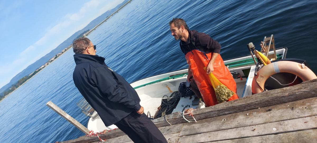 Un mariscador en la batea de control de O Bohído.