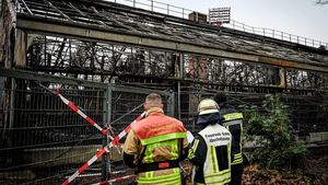 Krefeld (Germany), 01/01/2020.- Firemen stand in front of the completely burned out ape house of the zoo in Krefeld, Germany, 01 January 2020. All animals, in total more than 30, died during the fire at the Krefeld Zoo in the New Year’s night. The dead animals include chimpanzees, orangutans and two older gorillas. The criminal police in Krefeld currently assume that so-called sky lanterns may have set the monkey house on fire on New Year’s Eve. According to reports, eye-witnesses had seen sky lanterns land on the roof of the building. (Incendio, Alemania) EFE/EPA/SASCHA STEINBACH