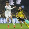 Fisnik Asllani of Hoffenheim (L) in action against Waldemar Anton of Dortmund (R) during the German Bundesliga soccer match between Borussia Dortmund and TSG Hoffenheim in Dortmund, Germany, 07 December 2025