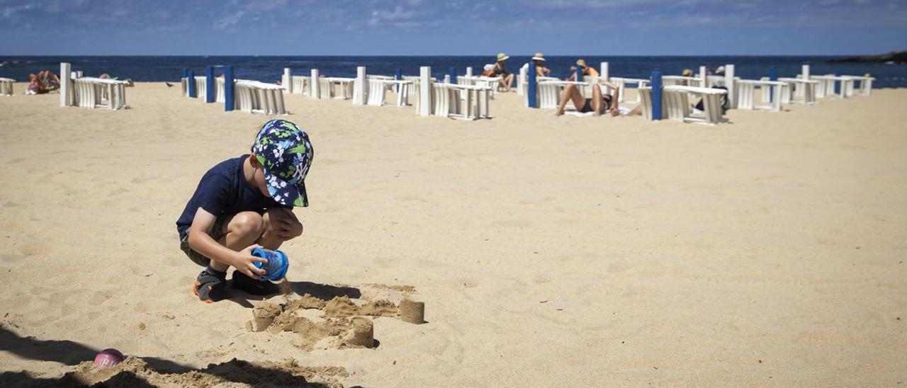 Un niño juega en la playa.