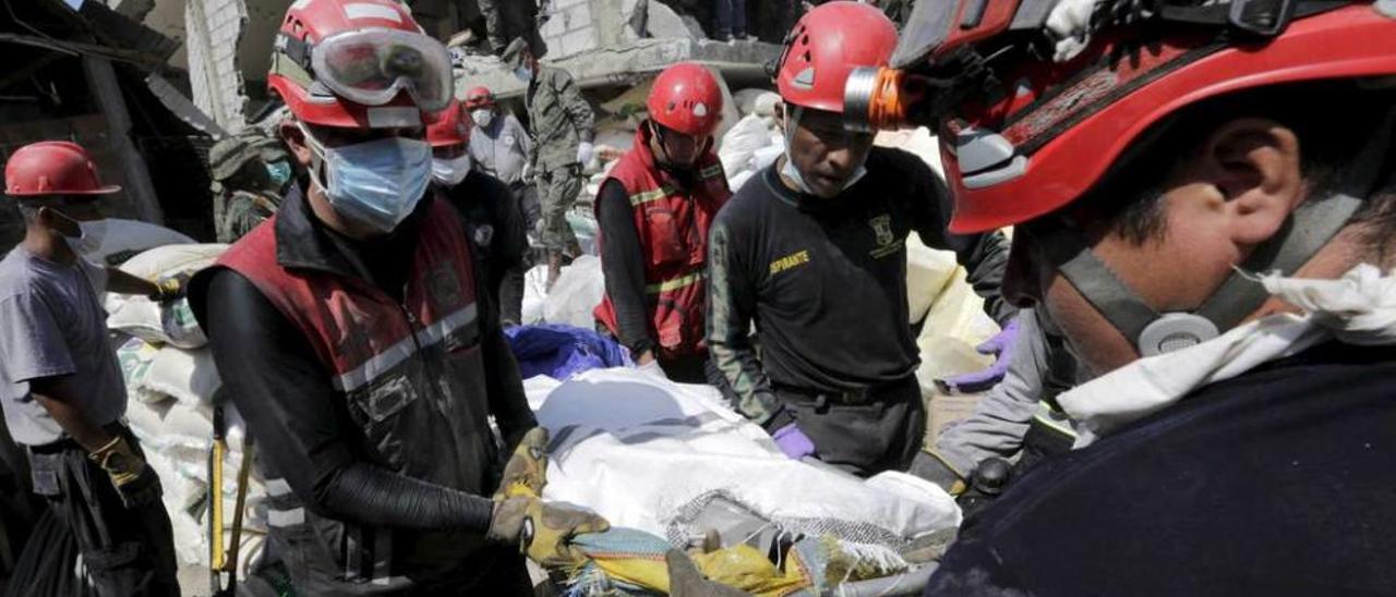 Los bomberos rescatan un cuerpo en la ciudad de Pedernales, una de las afectadas por el seísmo.