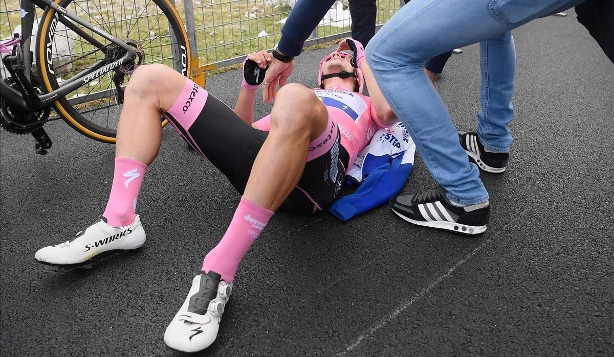 segea55478191 team deceuninck rider portugal s joao almeida lies on the gr201018172810