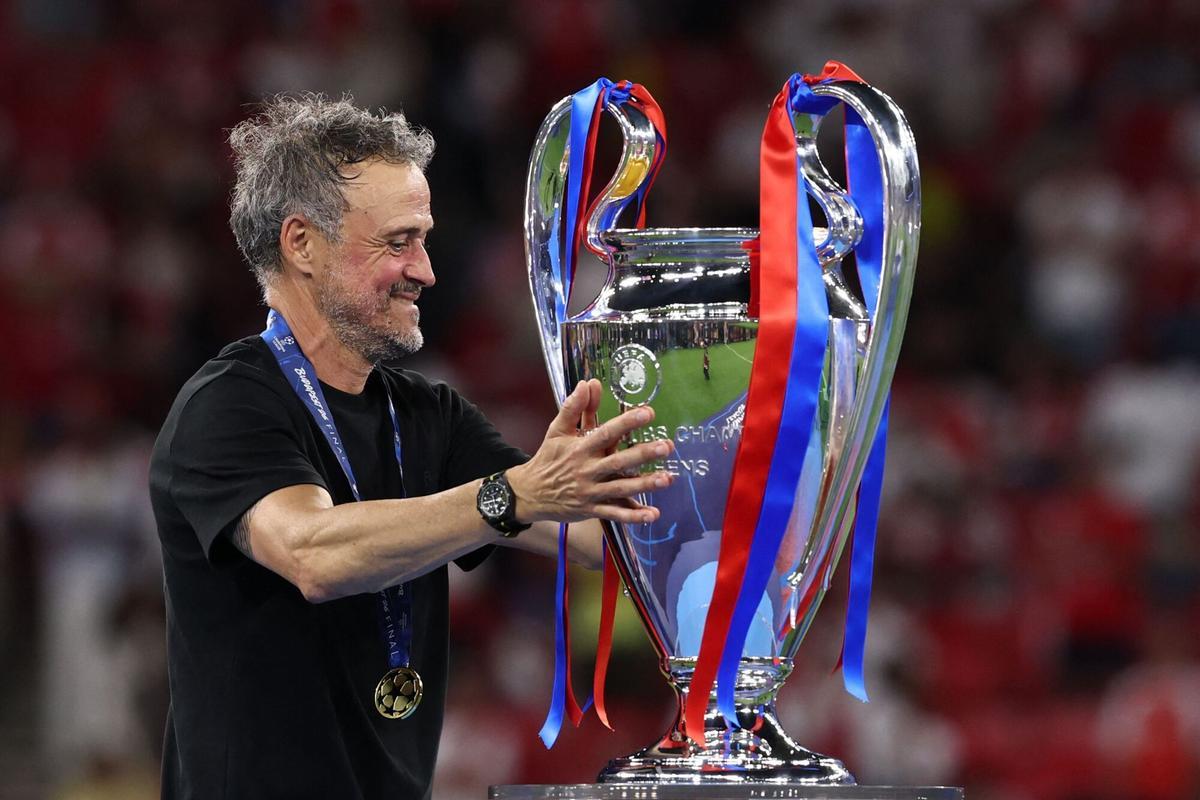 Paris Saint-Germain's Spanish head coach Luis Enrique touches the trophy after winning the UEFA Champions League final football match between Paris Saint-Germain (PSG) and Arsenal FC at the Puskas Arena in Budapest on May 30, 2026. Paris Saint-Germain beat Arsenal 4-3 on penalties to win their second consecutive Champions League title after a 1-1 draw in the final in Budapest on May 30. (Photo by FRANCK FIFE / AFP)