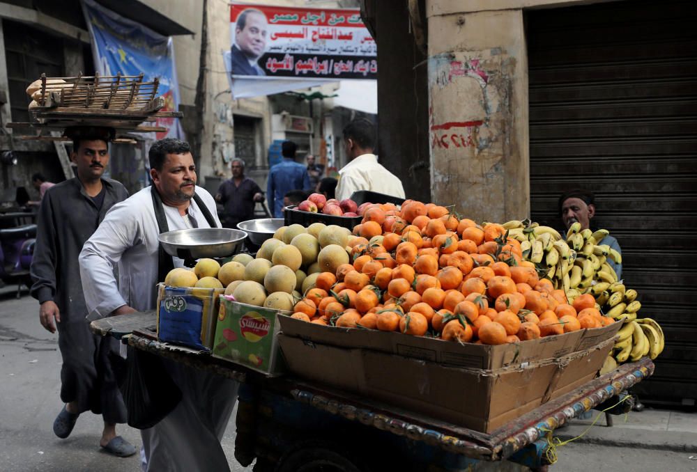An Egyptian fruit seller is seen at a market in ...