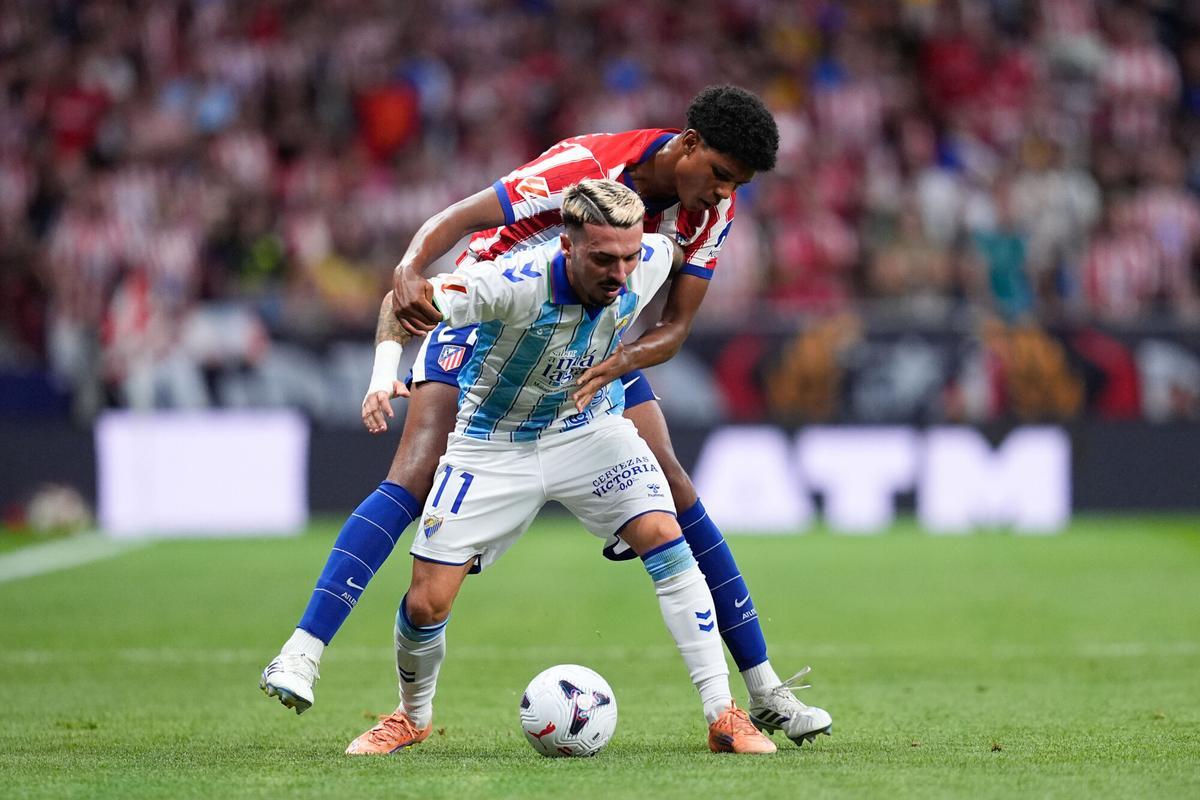 Joaquin Munoz of Malaga CF and Jorge Dominguez of Atletico de Madrid compete for the ball during the Spanish League, LaLiga EA Sports, football match played between Atletico de Madrid and Malaga CF at Riyadh Air Metropolitano stadium on August 19, 2026, in Madrid, Spain. AFP7 19/08/2026 ONLY FOR USE IN SPAIN. Dennis Agyeman / AFP7 / Europa Press;2026;SOCCER;SPAIN;SPORT;ZSOCCER;ZSPORT;Atletico de Madrid v Malaga CF - LaLiga EA Sports;