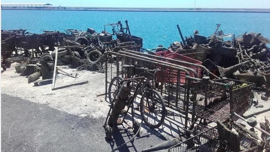 Los operarios encontraron en el fango del puerto de Alicante baterías, neumáticos, carritos y hasta una vespa