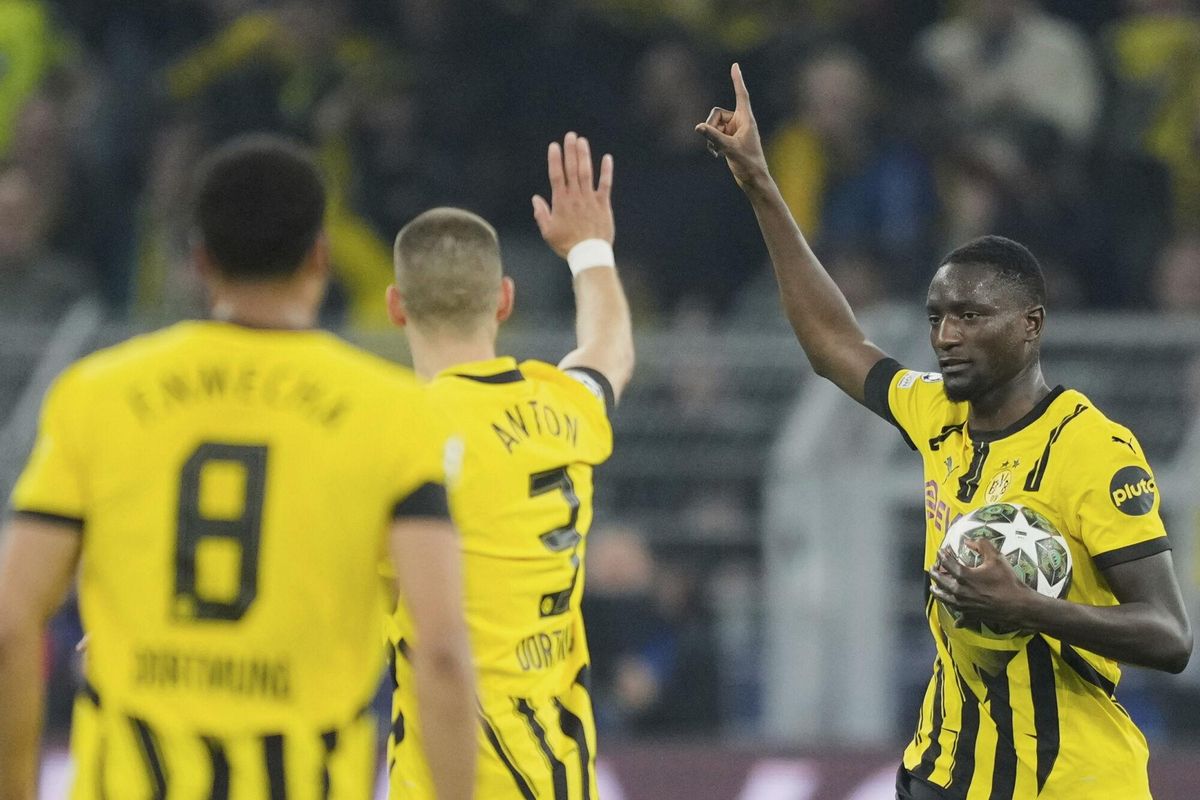 Dortmunds Serhou Guirassy, right, celebrates after scoring the opening goal during the Champions League quarterfinals second leg soccer match between Borussia Dortmund and Barcelona, at the Signa-Iduna Park in Dortmund, Germany, Tuesday, April 15, 2025. (AP Photo/Martin Meissner). EDITORIAL USE ONLY/ONLY ITALY AND SPAIN