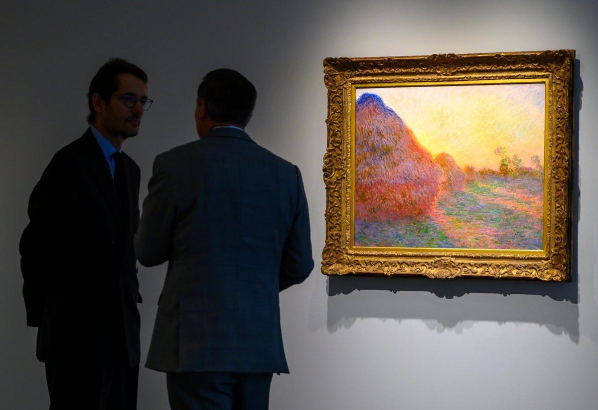 FILES In this file photo taken on May 02 2019 Sotheby s officials stand near one of Claude Monet s Meules during a media preview for Sotheby s Impressionist Modern Art and Contemporary Art auctions in New York - Monet s painting Haystacks Series Meules from 1890 was sold for 100 7 million at Sotheby s New York setting a record for Monet and for any work of Impressionist Art Photo by Don Emmert AFP RESTRICTED TO EDITORIAL USE - MANDATORY MENTION OF THE ARTIST UPON PUBLICATION - TO ILLUSTRATE THE EVENT AS SPECIFIED IN THE CAPTION FILES In this file photo taken on May 02 2019 Sotheby s officials stand near one of Claude Monet s Meules during a media preview for Sotheby s Impressionist Modern Art and Contemporary Art auctions in New York - Monet s painting Haystacks Series Meules from 1890 was sold for 100 7 million at Sotheby s New York setting a record for Monet and for any work of Impressionist Art Photo by Don Emmert AFP RESTRICTED TO EDITORIAL USE - MANDATORY MENTION OF THE ARTIST UPON PUBLICATION - TO ILLUSTRATE THE EVENT AS SPECIFIED IN THE CAPTION