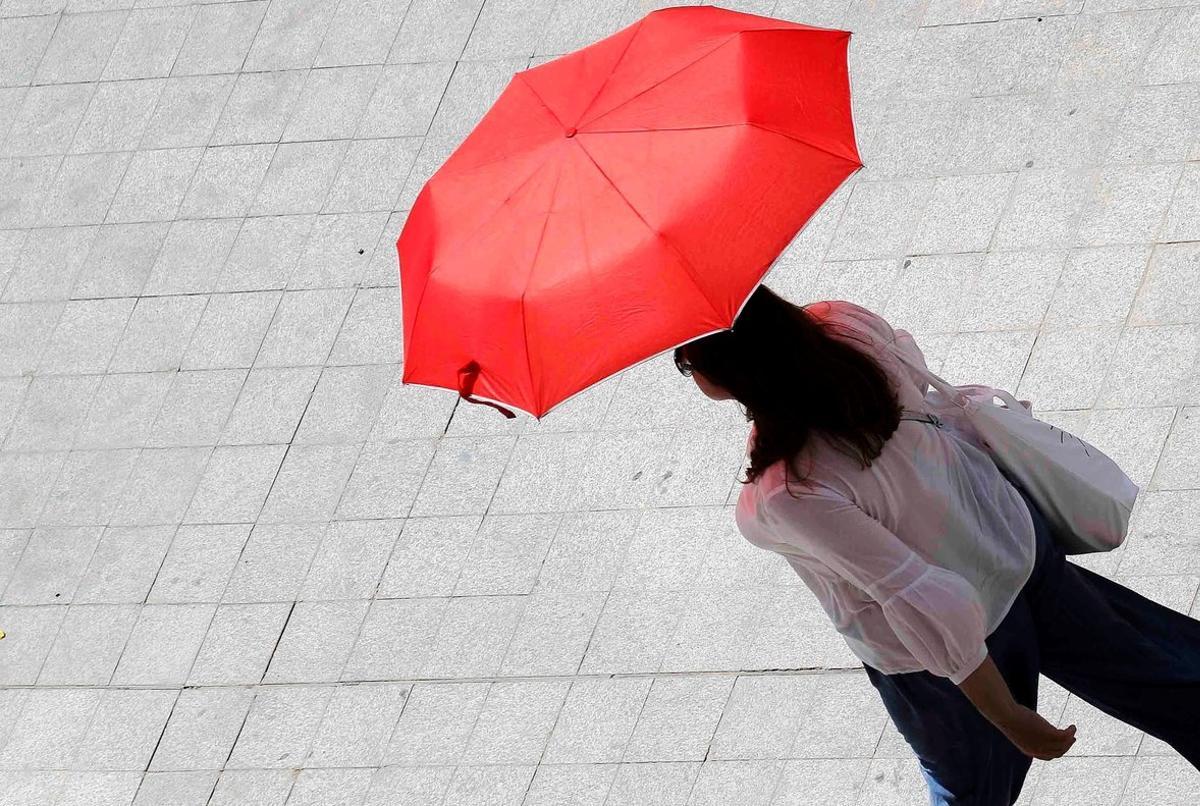 GRAFCVA6721  VALENCIA  24 07 2019 - Una mujer se protege del sol y del calor con un paraguas este miercoles en Valencia  cuando el calor intenso que desde el fin de semana afecta a numerosas zonas del pais mantiene la provincia de Valencia en alerta amarilla por valores de entre 35 y 37 grados  segun ha informado la Agencia Estatal de Meteorologia  Aemet  en su web  EFE Ana Escobar