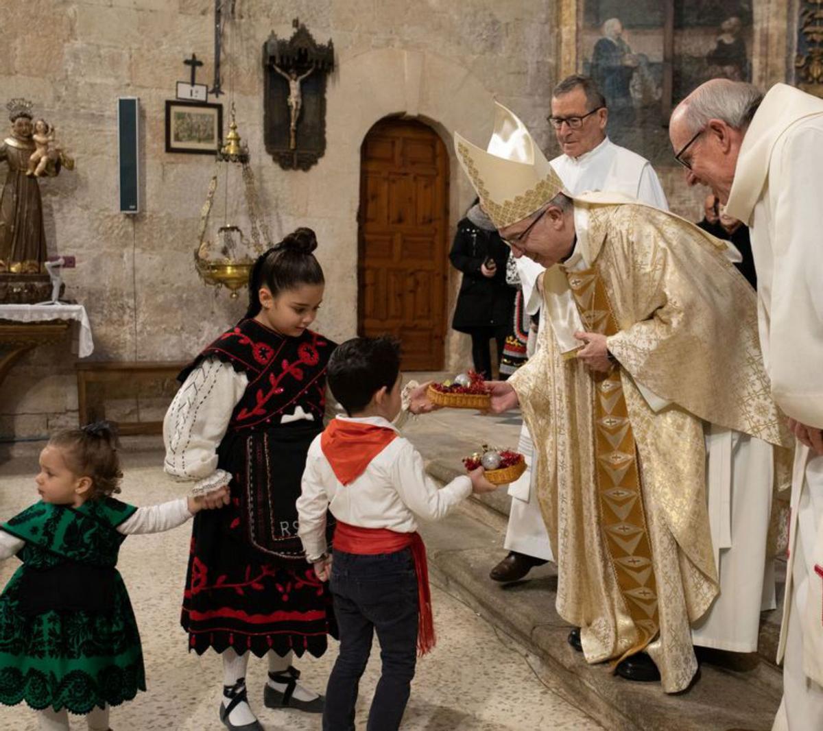 El obispo recibe las ofrendas de los niños. | A. B.