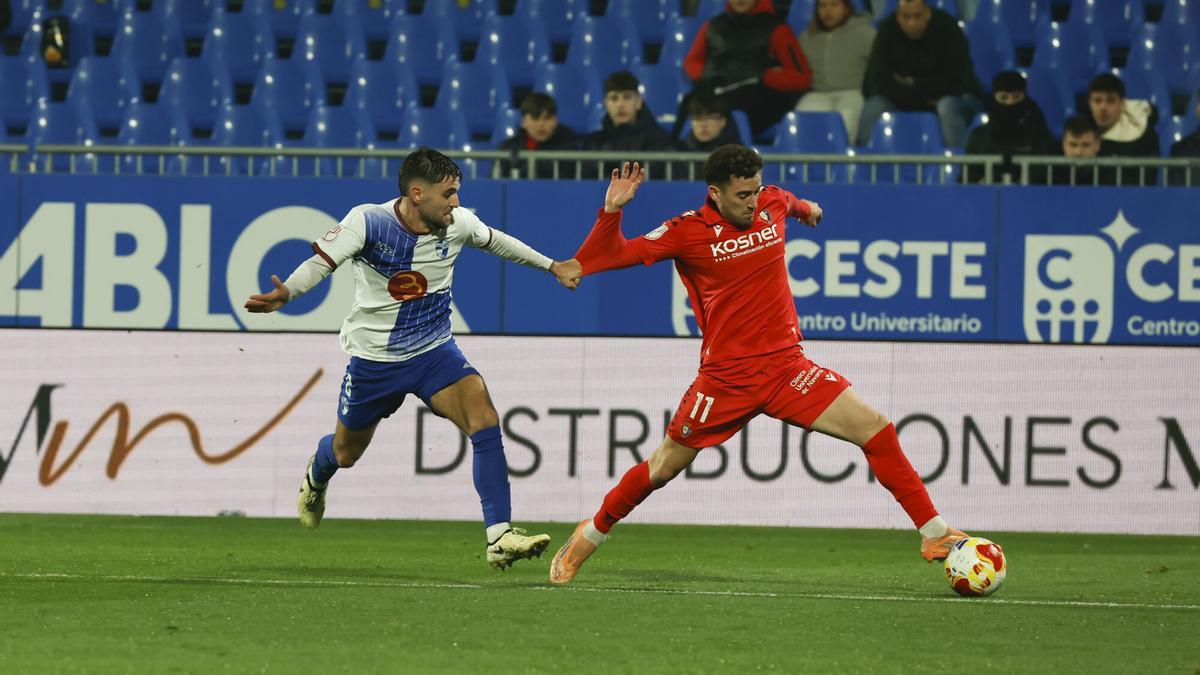 El delantero de Osasuna Kike Barja en acción ante el jugador del CD Ebro, Ángel Rueda, durante el partido de dieciseisavos de final de la Copa del Rey