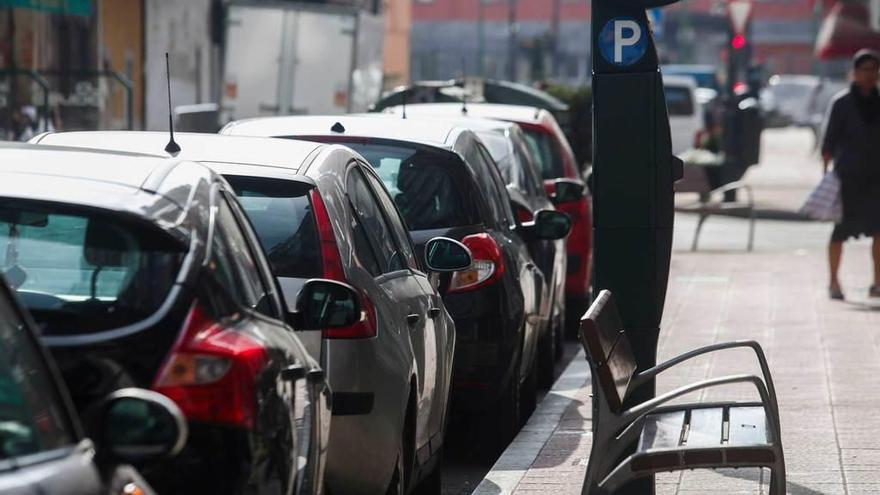 Vehículos estacionados en la zona azul en el barrio del Carbayedo.