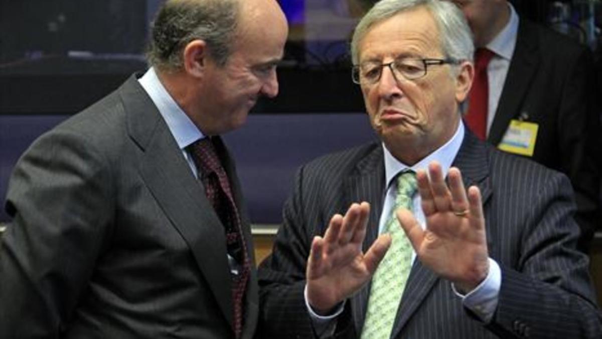 Luis de Guindos (izquierda), con el presidente de la Comisión Europea, Jean-Claude Juncker, en octubre del 2012.