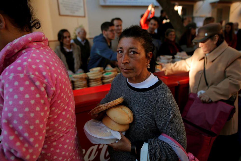 A woman holds food during a daily food ...