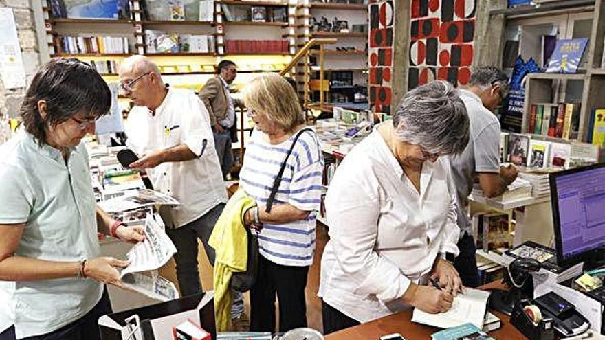 Dos dels autors guardonats, Barderi i Prats (d&#039;esquena), signant llibres a Les Voltes.