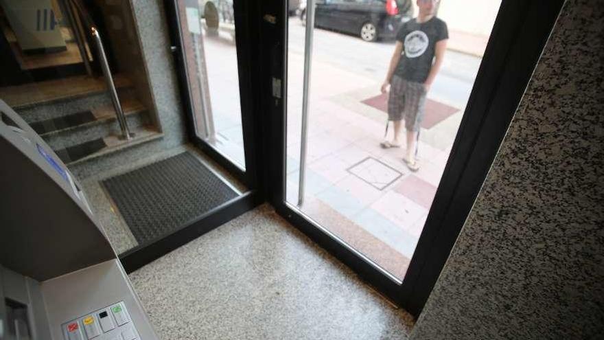 Un cliente de una sucursal bancaria de Lalín aguarda para entrar en el cajero. // Bernabé/Gutier
