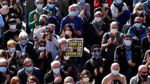 undefined55478717 topshot   people gather as as person holds a cover of french201019091024