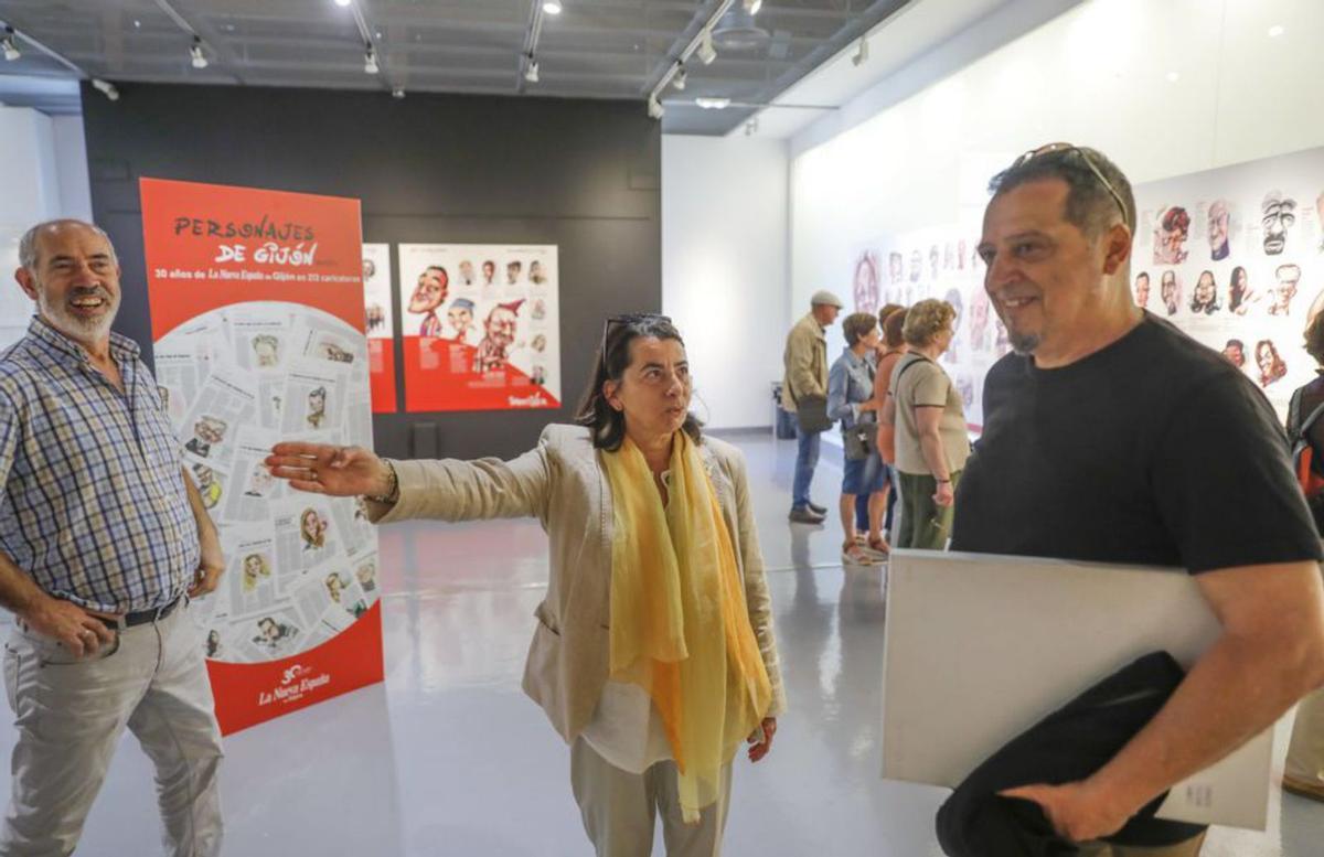 Por la izquierda, Raúl Marcos, Marcelina Rodríguez y Suso Pérez Loza, «Mortiner», ayer, en la exposición «Personajes de Gijón». | Marcos León