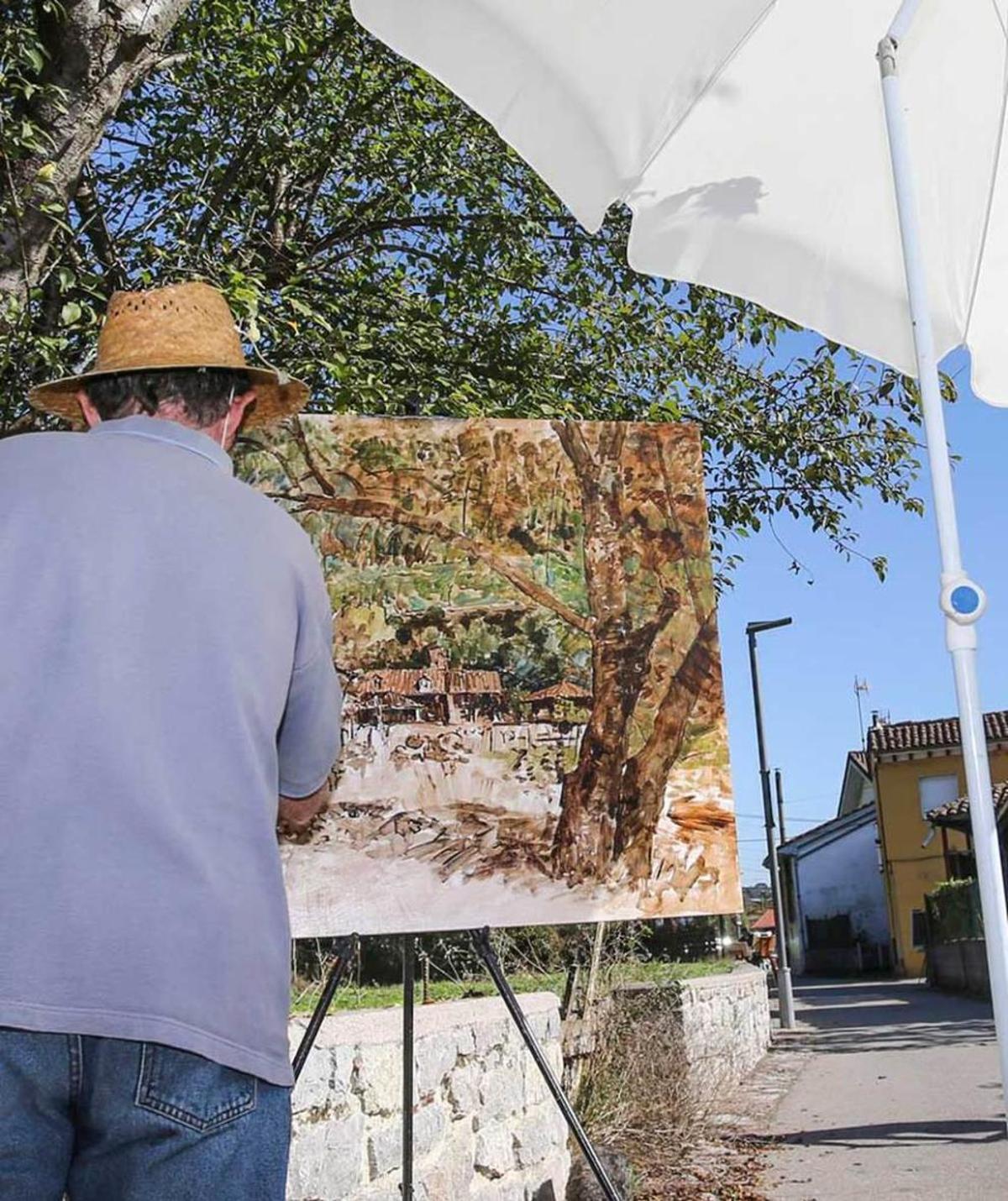 Pintor y caballete con hórreo al fondo