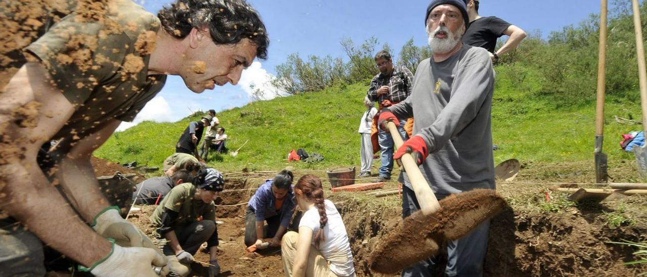 El antropólogo Paco Etxebarría retira tierra con una pala, con el arqueólogo Antxoka Martínez en primer término