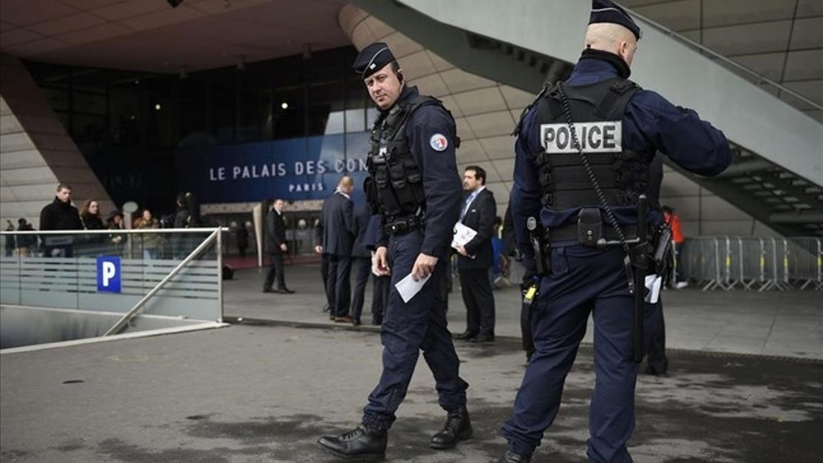 Agentes de la policía patrullan ante el Palacio de Congresos de París, donde se celebro el sorteo para la final del Campeonato de Europa de fútbol.