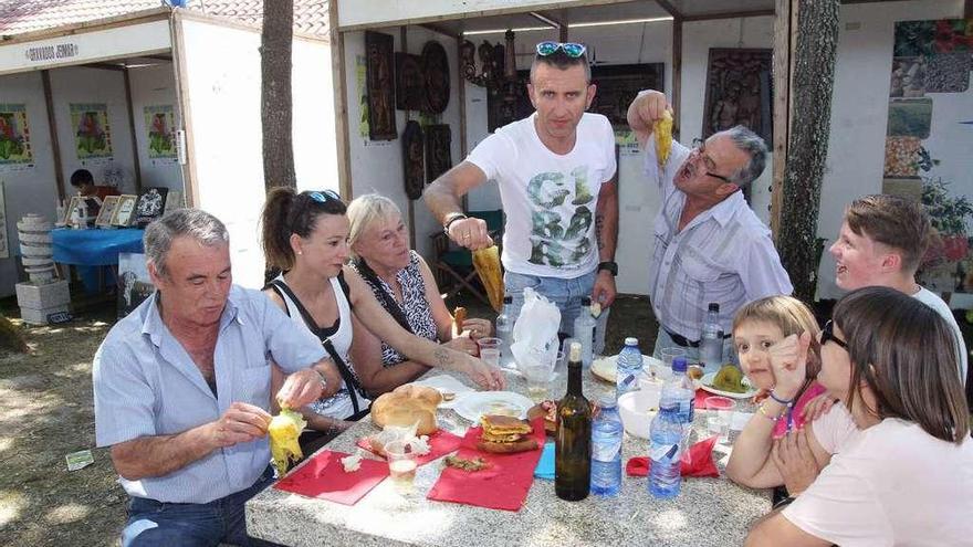 Una familia degusta el producto típico del día en A Festa do Pemento de Oímbra. // Iñaki Osorio